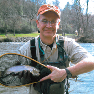 Judge James Humphrey holding a fish he caught in a net.