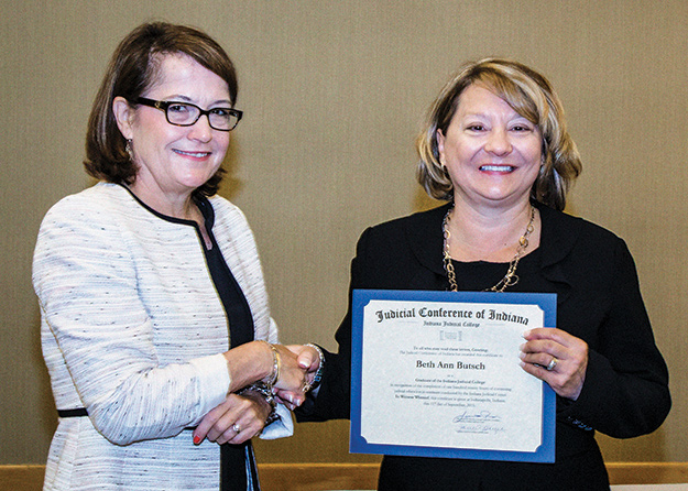 Judge Beth Ann Butsch receives a certificate from Chief Justice Loretta Rush after graduating the Indiana Judicial College in 2015.