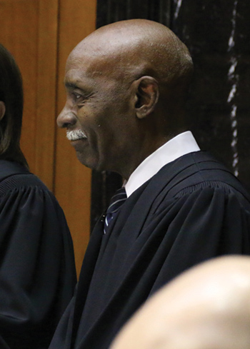 Justice Rucker stands during the State of the Judiciary address in the House chamber.