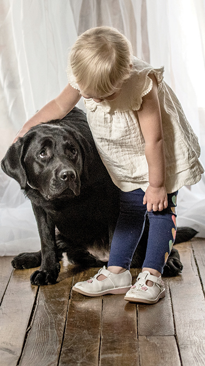 Frankie, the CASA dog, with young girl