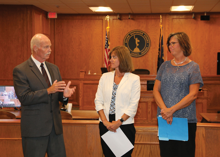 Allen County Commissioners Nelson Peters and Therese Brown, present the Commissioners’ Civil Service Award to Trish Gratz, Court Reporter to Judge Craig Bobay.