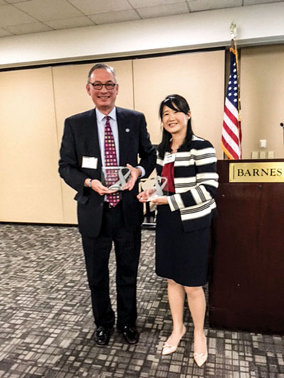 G. Michael Witte accepts a Trailblazer Award from Melissa Lin