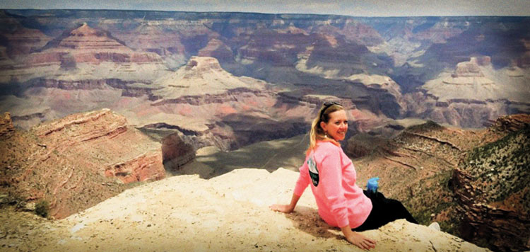 Judge Andrea K. McCord sits on the edge of the Grand Canyon