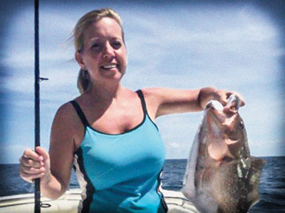 Judge McCord holds up a fish that she caught.