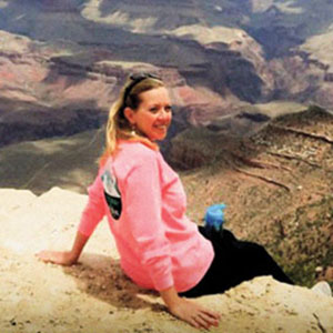 Judge Andrea K. McCord sits on the edge of the Grand Canyon.