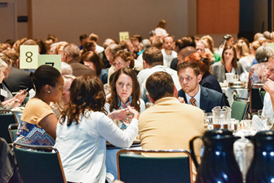 Attendees of the Statewide Opioid Summit engage in discussion during the working lunch.