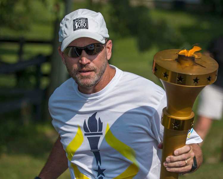 Wayne County Judge Darrin Dolehanty carries the bicentennial torch during a relay in celebration of the Indiana Bicentennial in 2016.