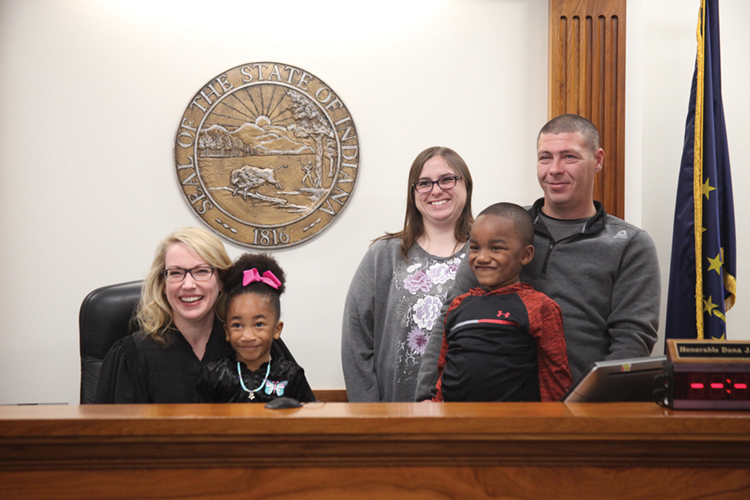 Judge Dana Kenworthy with a family during an adoption proceeding in Grant County