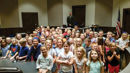 Judge Foley with a group of third-grade students.