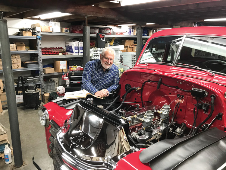 Marshall County Judge Dean Colvin works on a 1953 red Chevrolet pickup truck.