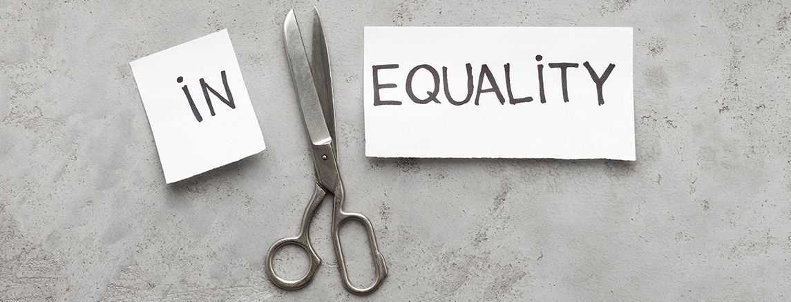 Scissors have cut the word "inquality" printed on paper, and the words "in" and "equality" remain