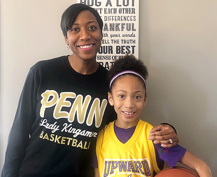 Magistrate Brisco and her daughter Alexa, who wears a yellow jersey while holding a basketball.