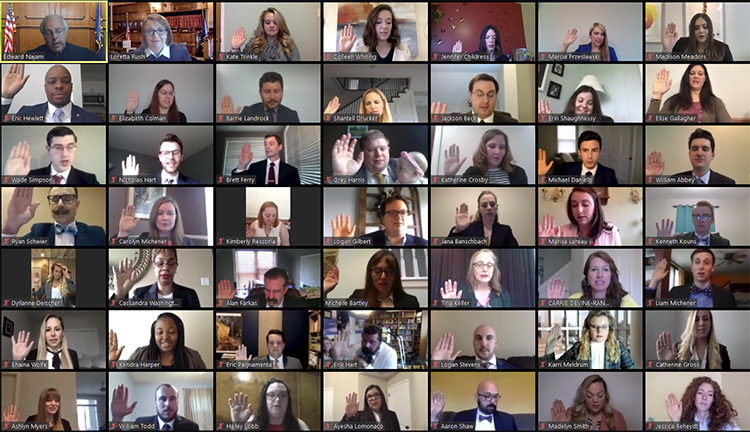 A grid of bar admittees raise their hands and recite the oath of attorneys during a virtual bar ceremony