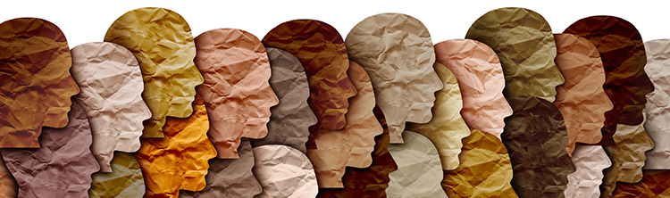 Decorative image of differently colored pieces of paper shaped like the profile of human faces overlapping one another, illustrating diversity.