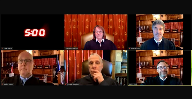 The Indiana Supreme Court is seen in a grid of screens as they appear by video conference to hear an oral argument. They each use photographs taken in the Supreme Court courtroom as virtual backgrounds.