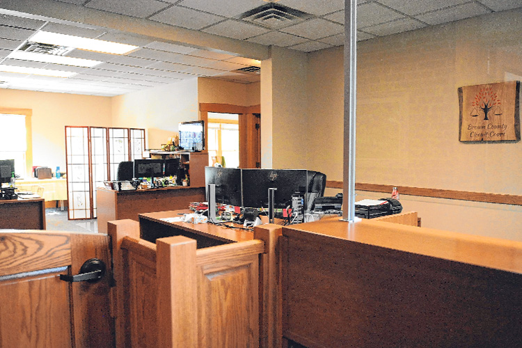 Newly constructed gate and new desks with computers on them are seen in the courthouse.