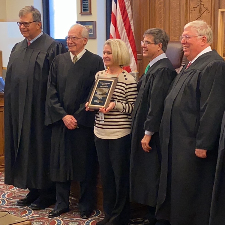 Stacey Beam stands alongside four Noble County judges.