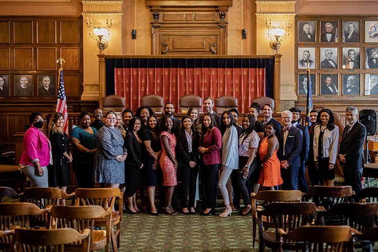 A group photo of the ICLEO fellows with the Supreme Court bench as a background.