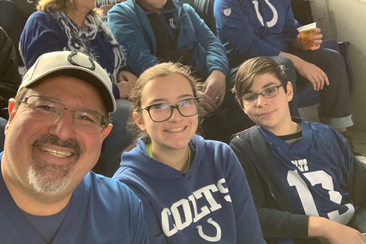 Judge Salinas and their kids wear blue Colts gear.