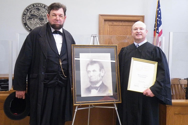 Judge John Dartt standing next to Abraham Lincoln impersonator, Dean Dorrell, at the commemoration for the Spencer County Courthouse.