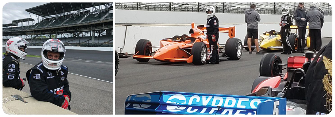 Judge Shively in full racing gear on the track waiting for his turn in a bright orange Indy car.