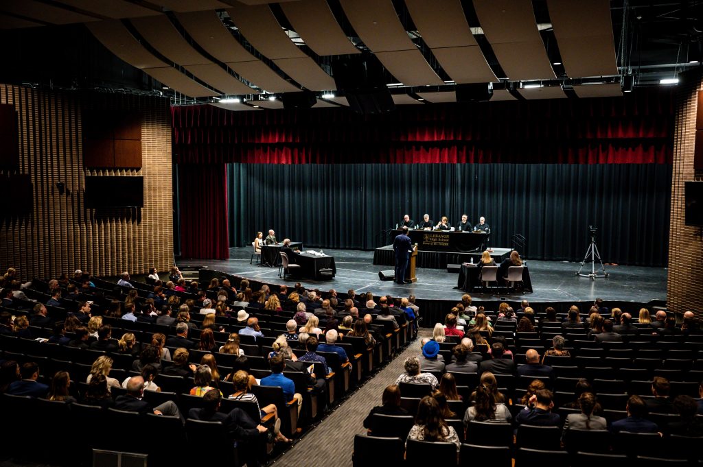 A wide shot of the auditorium at Lebanon High School during the argument.