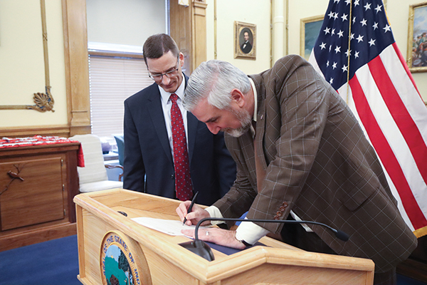 Governor Eric Holcomb signs a declaration appointing Judge Peter Foley to the Court of Appeals.