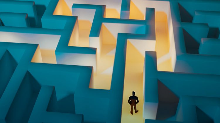 Birdseye view of a man in a maze, the path to exit is illuminated to show him the way.