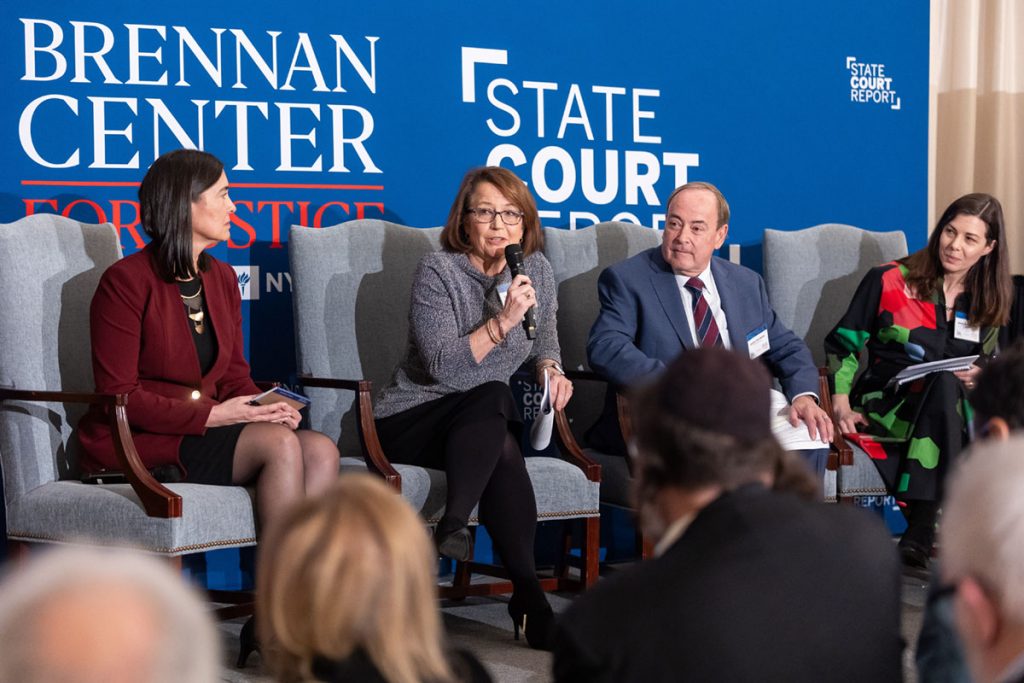 Chief Justice Loretta Rush sits with other panelists and answers a question.