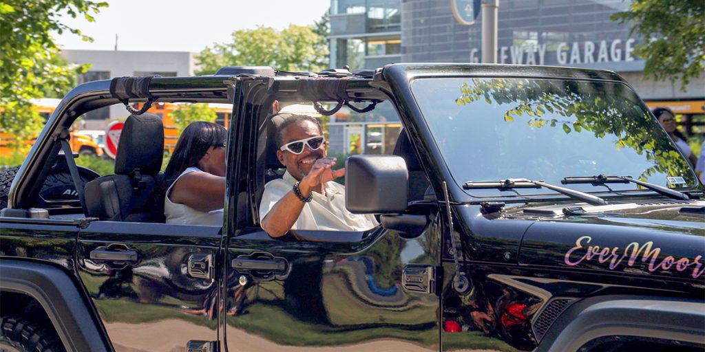 Photo of Judge Geoffrey Gaither waving from a car to the crowd during the Indy Juneteenth Celebration parade.