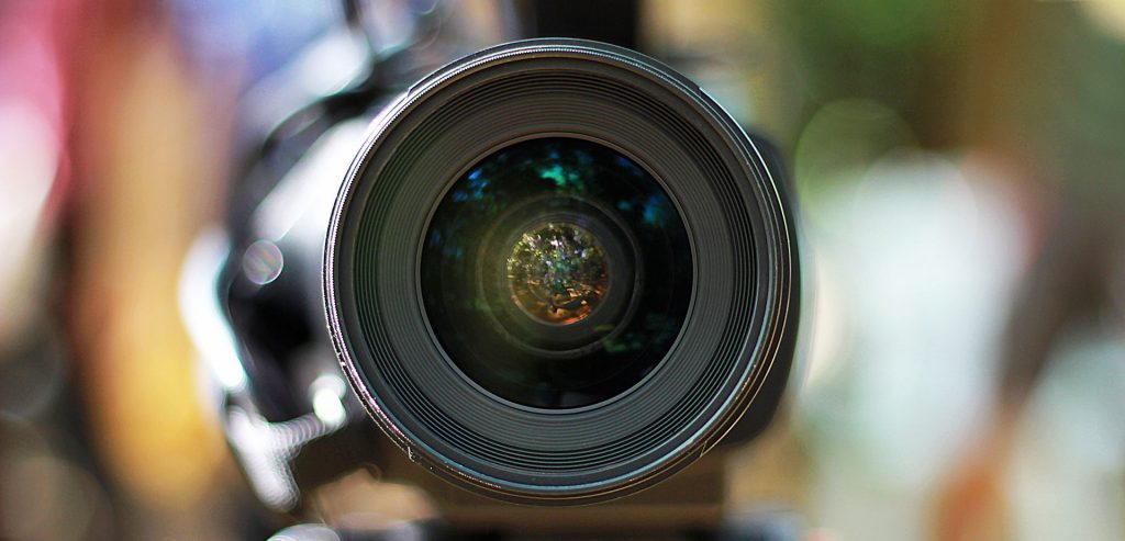 A camera lens with a blurred background.