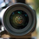 A camera lens with a blurred background.