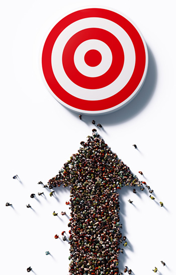 Crowd of people in birdseye view forms an arrow pointing toward a red and white target.