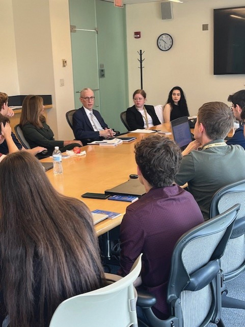 People sit around a table having a discussion.