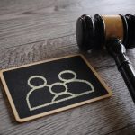 Closeup image judge gavel and chalkboard with family icon.