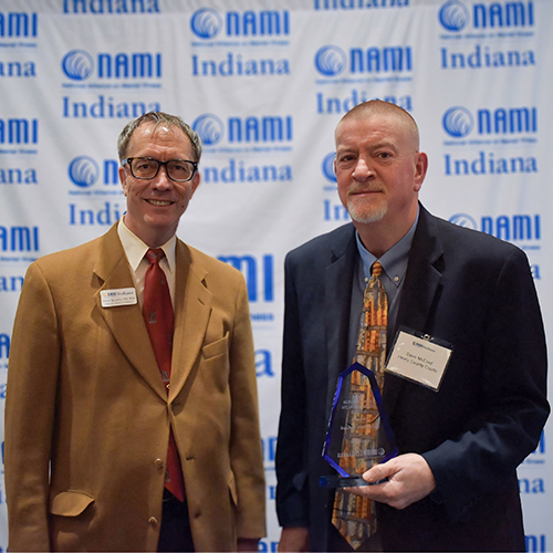 NAMI Board Member, Dr. David Spradley stands with Judge David McCord, who is holding his award.