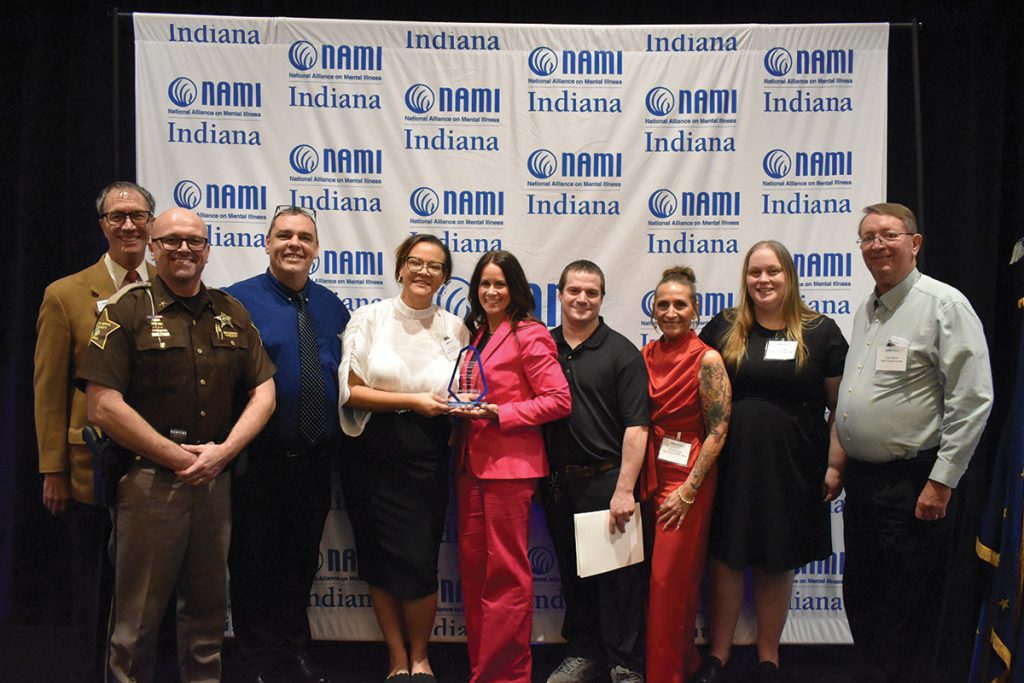 A group of people stand to accept their award.