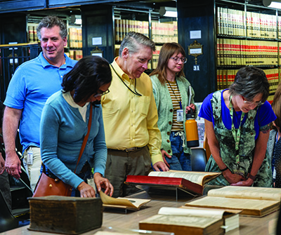 Employees looking at rare book collection.